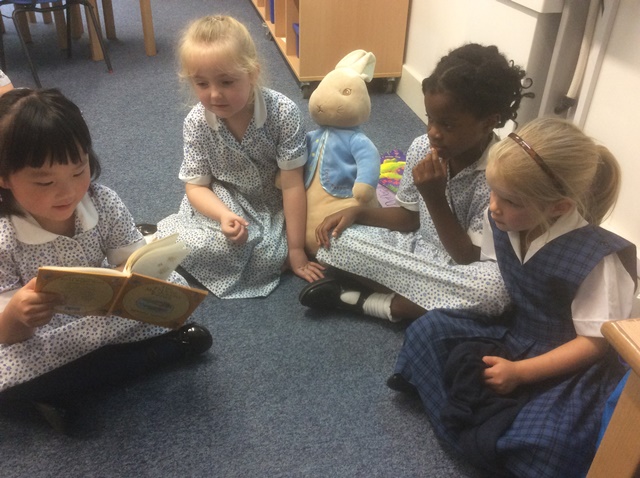 Year 1 pupils reading Beatrix Potter
